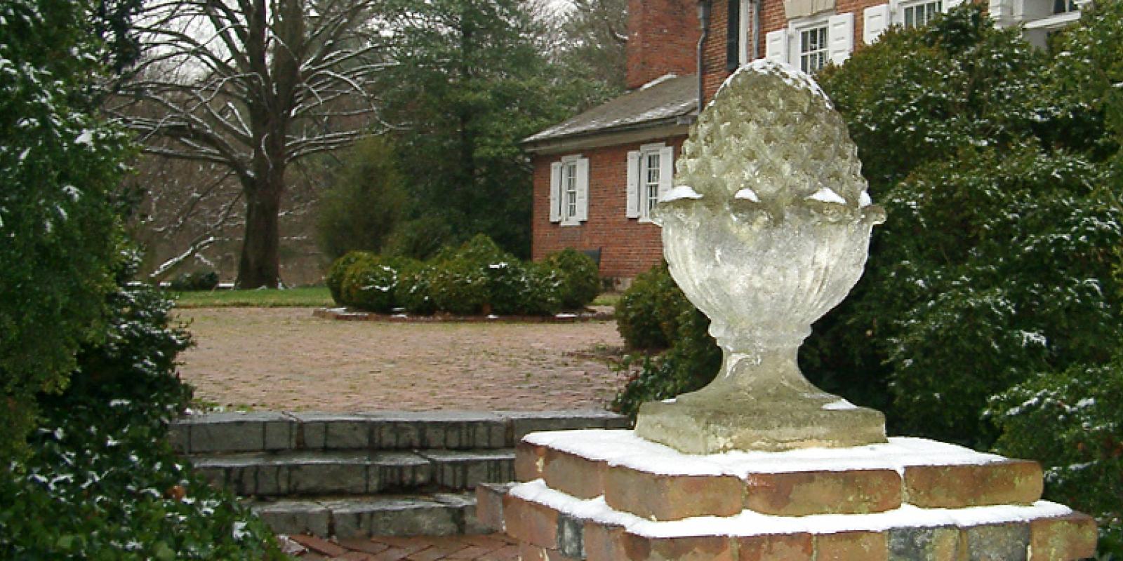 Colonial Revival style garden pineapple gate ornament at the entry of the Corbit-Sharp House